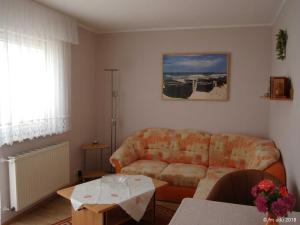 a living room with a couch and a table at Ferienhaeuser Baaber Heide in Baabe