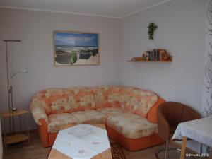 a living room with a couch and a table at Ferienhaeuser Baaber Heide in Baabe