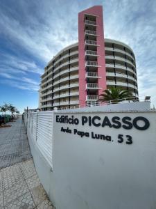 ペニスコラにあるAlpen1 Picassoのエリートのパスコサオサ パプアパプアを読む看板のある建物