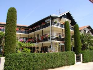 a large white building with bushes in front of it at Rooms in Vodice with balcony, air conditioning, WiFi 4826-1 in Vodice