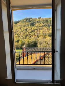 a window with a view of a mountain at La Rollinoise in Valsonne
