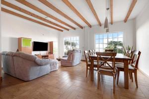 a living room with a table and a dining room at Casa Luz in La Luz