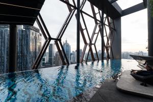 a pool on the top of a skyscraper at Scarletz KLCC Studio Suites 4 pax Luxury Modern Style WiFi 100Mbps in Kuala Lumpur
