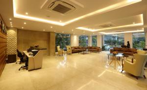 a large lobby with couches and tables and chairs at Resort The Lohias, Goa Candolim in Candolim