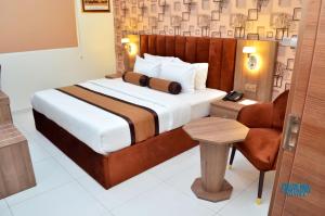 A bed or beds in a room at Proxima Centauri Hotel