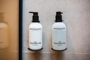 two bottles of hair products sitting on a shelf at Haven Lake Village in Kortenhoef