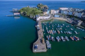 an aerial view of a harbor with boats in the water at Cariad Llyyad Y Dydd - 1 Bedroom Apartment - Tenby in Tenby