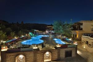 an outdoor swimming pool at a resort at night at Holiday Cave Hotel in Goreme