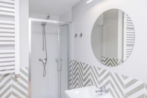 a bathroom with a shower and a mirror at Metro Bielany Apartments with Parking by Renters in Warsaw