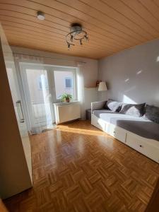 a bedroom with a large bed and a wooden floor at Schöne Wohnung mit eigenem Eingang und Parkplatz in Fulda