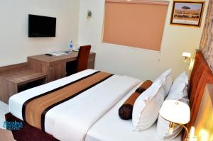 A bed or beds in a room at Proxima Centauri Hotel