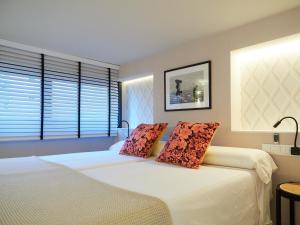 1 dormitorio con 1 cama con 2 almohadas en Oktheway Oza Park, en A Coruña