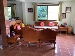 a living room with a couch and a piano at Nantawanhomestay in Lampang