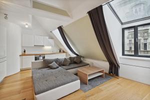 ein Wohnzimmer mit einem Sofa und einem Fenster in der Unterkunft Florian's apartments in Mariahilf Vienna in Wien