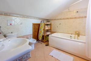 a bathroom with a tub and a toilet and a sink at Apartments villa MaVeRo in Banjole +37 photos