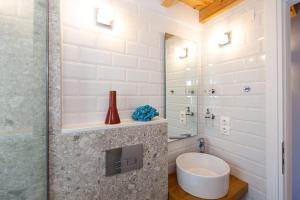 a bathroom with a toilet and a glass shower at Nona´s Dorf Haus in Liapades in Liapades