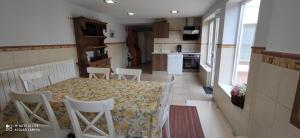 a kitchen with a table and chairs in a room at Casa La Manzanera in Burgos +11 photos