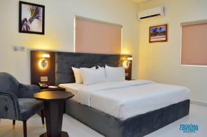 A bed or beds in a room at Proxima Centauri Hotel