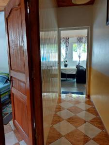 a hallway with a door leading to a living room at Chez Framboise in Salazie