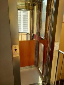 a glass elevator in a room with a door at greth house in Naples