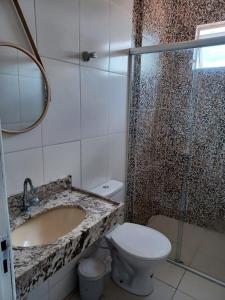 a bathroom with a sink and a toilet and a shower at Apartamento em Camboinha in João Pessoa