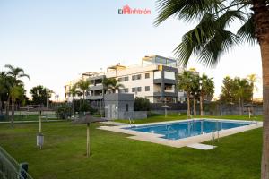 a resort with a swimming pool and a building at El Anfitrión - Barra del río in Sanlúcar de Barrameda