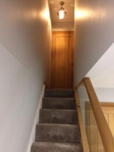 a staircase in a house with a stair case at River Road, Littlehampton, Executive Apartment in Littlehampton