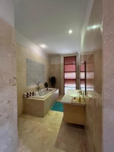 a large bathroom with a tub and a sink at Villa Gekyu in Jimbaran