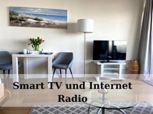 a living room with a smart tv and internet radio at Top - Seaside Appartement mit Meerblick in Timmendorfer Strand
