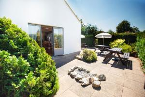 a patio with a picnic table and an umbrella at Campanile Hotel Doncaster in Doncaster