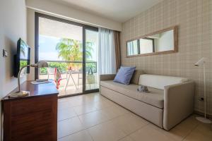 a living room with a couch and a large window at Estival Isla Cristina in Isla Cristina