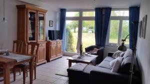 a living room with a couch and a table at Ferienwohnung A2 im Landhaus am Haff in Stolpe auf Usedom