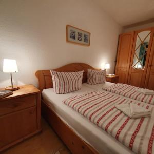 a bedroom with a large bed with a wooden headboard at Ferienwohnung A2 im Landhaus am Haff in Stolpe auf Usedom