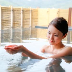 a woman is sitting in a bath tub at Kyukamura Minami-Awaji in Minamiawaji