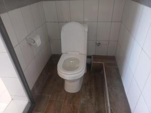 a bathroom with a white toilet in a stall at Maranda Deluxe Double Seaview room - B&B with pool. in Ukunda +13 photos