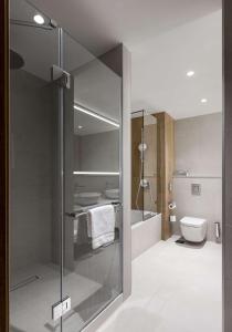 a bathroom with a glass shower and a toilet at Radisson Blu Hotel, Kyiv City Centre in Kyiv