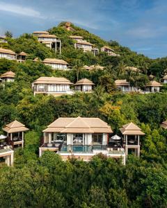 a group of houses on top of a hill at Banyan Tree Samui in Lamai