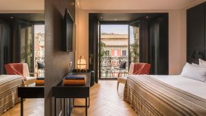 a hotel room with two beds and a balcony at Hotel Casa Sagnier in Barcelona