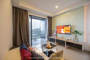 a living room with a couch and a tv at Premium Suites D'lement At Genting Highlands in Genting Highlands