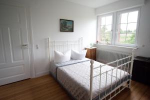 a bedroom with a white bed with two pillows on it at Wohnen im alten Pfarrhaus in Herbolzheim