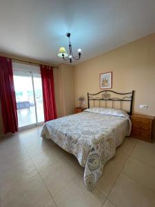 a bedroom with a bed and a large window at Alpen1 Argenta/Caleta in Peniscola