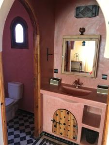 a bathroom with a sink and a mirror at Riad Moha in Merzouga