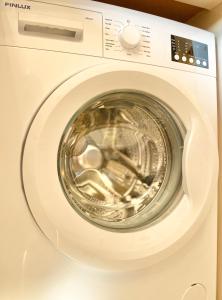 a white washing machine with its door open at Business & Family Apartment for 6 Guests with Free Parking in Stara Zagora