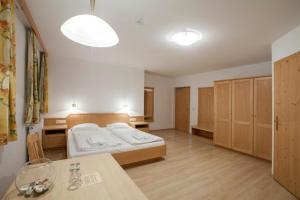 Hotel Kammerhof في Mariastein: غرفة نوم بسرير وطاولة في غرفة