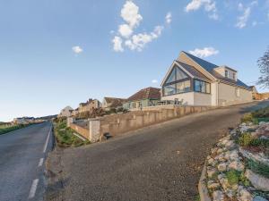 a house on the side of a road at Crug Y Bar in Gwbert