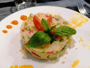 a white plate with a piece of food on it at Riad Moha in Merzouga