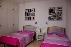 two beds sitting next to each other in a room at Casa Regla in Puerto del Carmen
