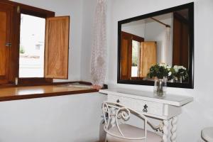 a bathroom with a white vanity and a mirror at Casa Regla in Puerto del Carmen