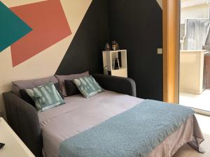a bedroom with a bed and a colorful wall at king's tower by Férias em Figueira in Figueira da Foz
