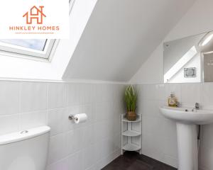 a white bathroom with a sink and a toilet at 5 Beds - Free Gated Parking - City Centre - By Hinkley Homes Short Lets & Serviced Accommodation in Liverpool